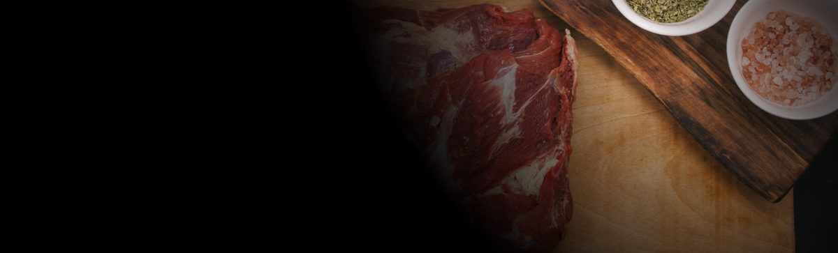 Carne sobre tabla — hero página Nosotros